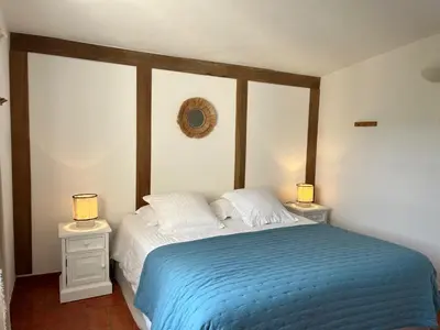 a bedroom with a bed with two night stands and two lamps at Domaine de la Bastidonne in Céreste