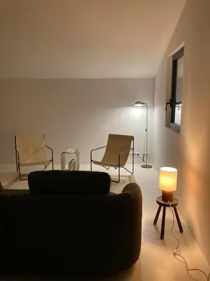 a living room with two chairs and a couch and a lamp at Le Jardin des Graminées in Cabrières-dʼAvignon