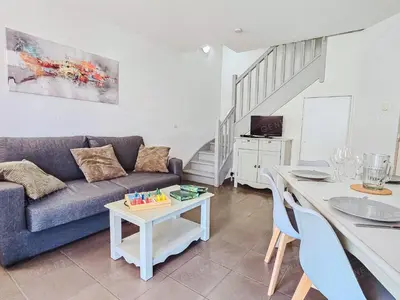 a living room with a couch and a table at Maison de vacances près du Mont Ventoux in Aubignan