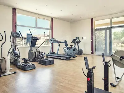 a gym with treadmills and exercise bikes in a room at Maison de vacances près du Mont Ventoux in Aubignan