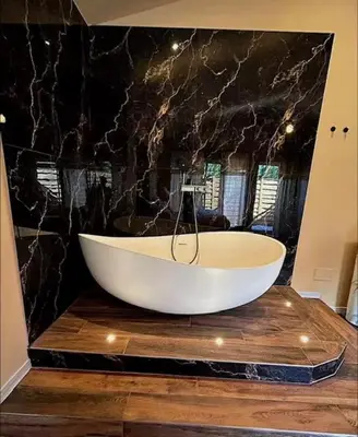 a white bath tub sitting on top of a wooden table at Chambre de charme indépendante Alba avec baignoire îlot - Domaine Astra, Grans in Grans