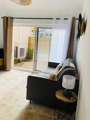 a living room with a couch and a table at Le studio de Marie in Noves