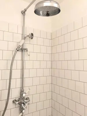 a shower with a shower head in a bathroom at Le Poulailler, private house with garden and parking in Aix-en-Provence