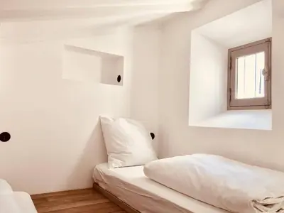a white room with a bed and a window at Le Poulailler, private house with garden and parking in Aix-en-Provence