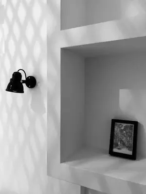 a light on a wall with a picture on a shelf at Le Poulailler, private house with garden and parking in Aix-en-Provence