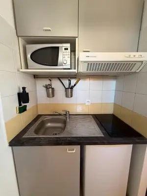 a kitchen with a sink and a microwave at Le Clos D'AIX Studio 108 in Aix-en-Provence