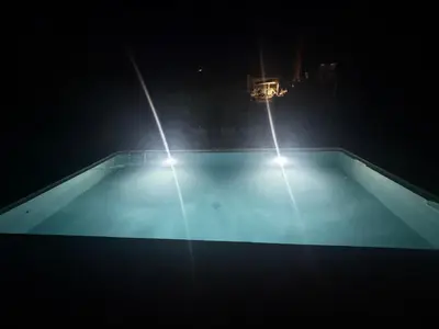 two lights on top of a swimming pool at night at Le Clos D'AIX Studio 108 in Aix-en-Provence