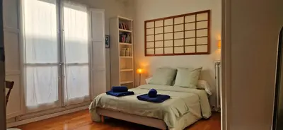 a bedroom with a bed with two blue hats on it at Spacious apartment 4 people parking, bright in Aix-en-Provence