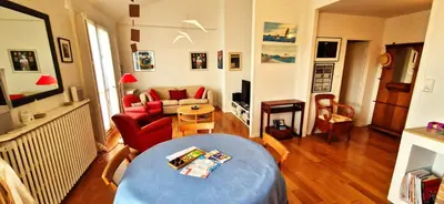 a living room with a couch and a table at Spacious apartment 4 people parking, bright in Aix-en-Provence