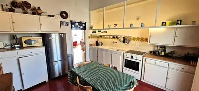 a kitchen with white cabinets and a table in it at Spacious apartment 4 people parking, bright in Aix-en-Provence