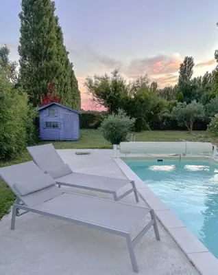 a pair of chairs and a swimming pool at Maison d'hôte en Provence avec petit déjeuner in Mollégès