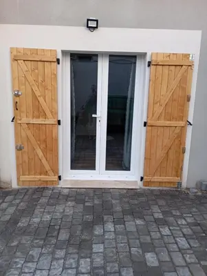 a pair of wooden doors on a house at studio in Morières-lès-Avignon