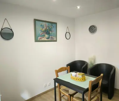 a dining room with a table and black chairs at studio in Morières-lès-Avignon
