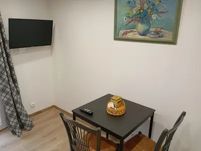 a table and chairs in a room with a television at studio in Morières-lès-Avignon