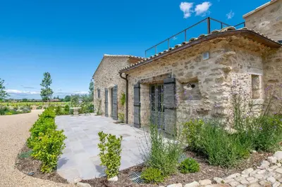 an old stone building with a pathway in front at La Bastide in Oppède