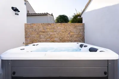 a bath tub in the corner of a building at La maison d'Alice - Calme - Climatisation - Parking privatif in Velaux