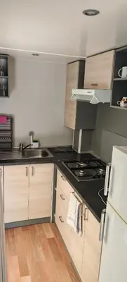 a kitchen with a sink and a stove top oven at Mobilhome 6 personnes in Cheval-Blanc
