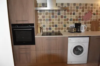 a kitchen with a washer and a dishwasher at Gite chez les Truph in Entraigues-sur-la-Sorgue