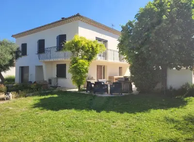 a large white house with a yard in front of it at Villa MOOREA pool barbecue PROVENCE in Entraigues-sur-la-Sorgue