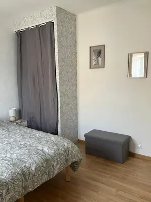 a bedroom with a bed and a dresser in it at Maison de village à Pertuis in Pertuis