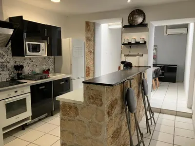 a kitchen with a stone counter top in a room at Maison de village à Pertuis in Pertuis