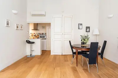 a kitchen and dining room with a table and chairs at Bel appartement près du Cours Mirabeau in Aix-en-Provence