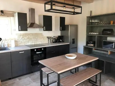 a kitchen with a wooden table with a bowl on it at Maison de charme in Monteux
