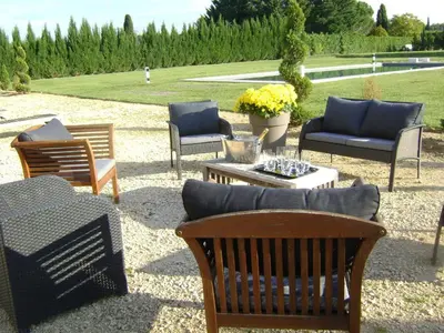 a group of chairs and tables in a yard at Bastide des Lauves in Aix-en-Provence