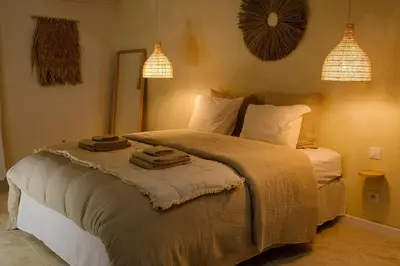 a bedroom with a bed with towels on it at AMA, suite avec baignoire balnéo et sauna privé in Avignon