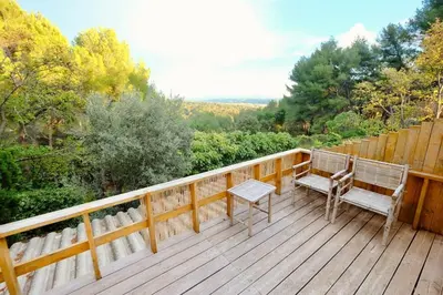 a deck with two chairs and a bench on it at L'Observateur in Aix-en-Provence