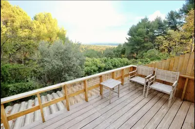 a deck with two chairs and a bench on it at L'Observateur in Aix-en-Provence
