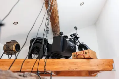 a motorcycle hanging from a ceiling with a camera at Duplex Factory II Hyper Centre in Salon-de-Provence