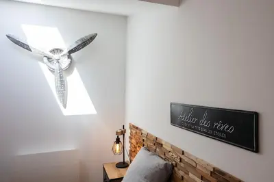 a bedroom with a ceiling fan and a brick wall at Duplex Factory II Hyper Centre in Salon-de-Provence