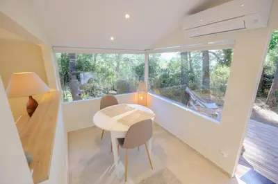 a room with a table and chairs and a large window at L'intimiste in Aix-en-Provence