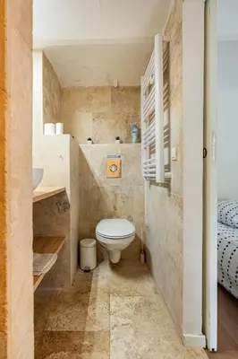 a small bathroom with a toilet and a sink at Le Dandy in Aix-en-Provence
