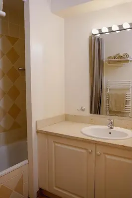 a bathroom with a sink and a mirror at Appartement Nature Golf de Saumane - Vue & Calme in Saumane-de-Vaucluse