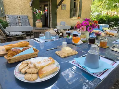 a blue table topped with plates of bread and pastries at l'Estagnol in Ansouis