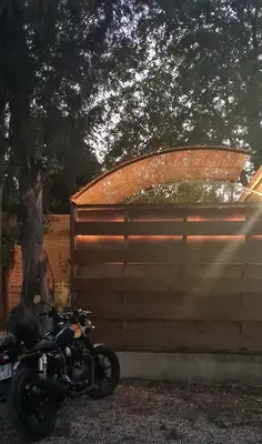 a motorcycle parked next to a wooden fence at La Chambrette in Salon-de-Provence
