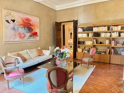 a living room with a couch and a table and chairs at L Appart Aixois in Aix-en-Provence