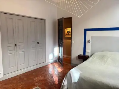 a bedroom with a bed and a hallway with a door at L Appart Aixois in Aix-en-Provence
