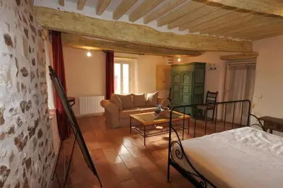 a living room with a couch and a table at Grande maison de village - solarium et terrasse in Saint-Martin-de-Castillon