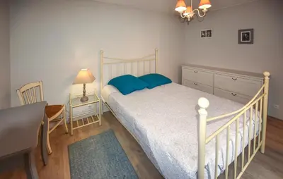 a bedroom with a bed with blue pillows and a desk at Lovely Home In Carpentras With Wifi in Carpentras