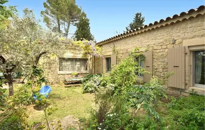 a brick building with a yard with a bench at Lovely Home In Carpentras With Wifi in Carpentras