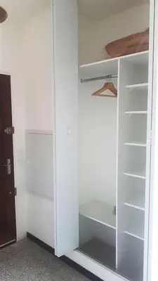 a closet with white walls and white shelves at GitesLuberon 1 studio in Charleval