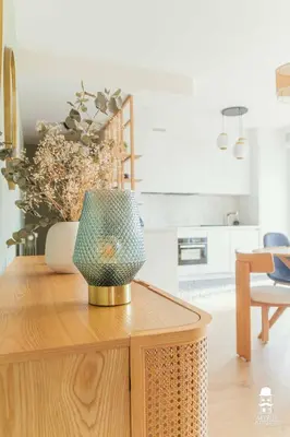 a kitchen with a table with a vase on it at Le Cézanne in Aix-en-Provence