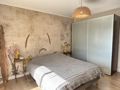 a bedroom with a bed and a wall at Les Cerisiers in Aix-en-Provence