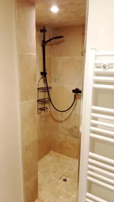 a shower with a glass door in a bathroom at Domaine des Hauts de Riganel in La Bastide-des-Jourdans