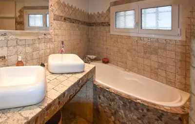 a bathroom with a tub and a sink at 2 Bedroom Lovely Home In Vedène in Vedène