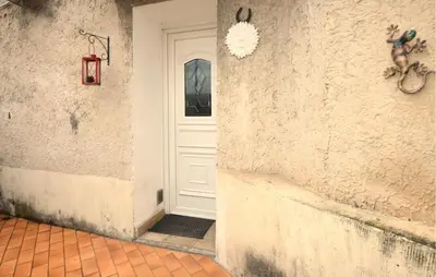 a white door in a white wall with a red tile floor at 2 Bedroom Lovely Home In Vedène in Vedène