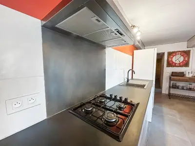 a kitchen with a stove top oven in a kitchen at Maison provençale de charme au cœur du Luberon in Saint-Saturnin-les-Apt